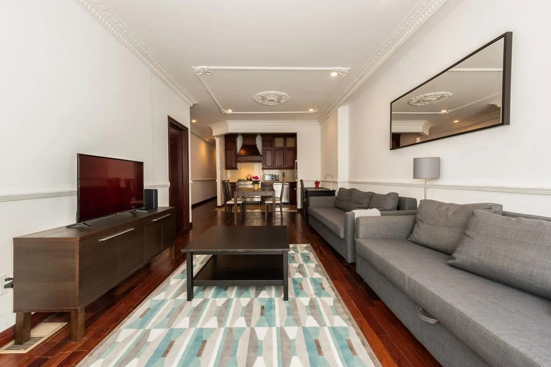 475 West 146th Street Manhattan, NY 10031 - Photo 6 of 19 a living room with furniture and a flat screen tv