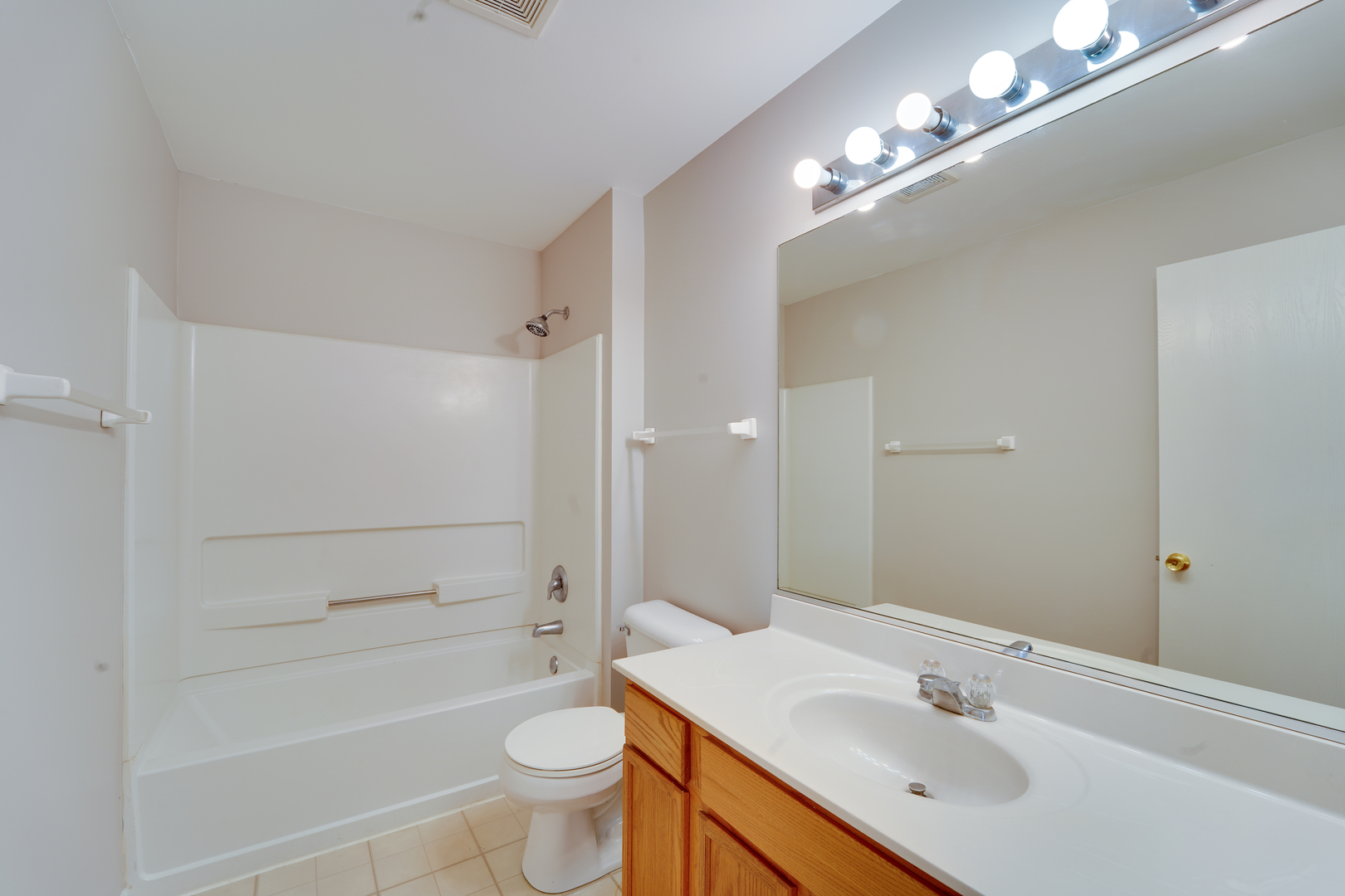 1231 Silverstone Drive, Unit 1231 Carpentersville, IL 60110 - Photo 14 of 22 a bathroom with a sink a toilet a mirror and shower