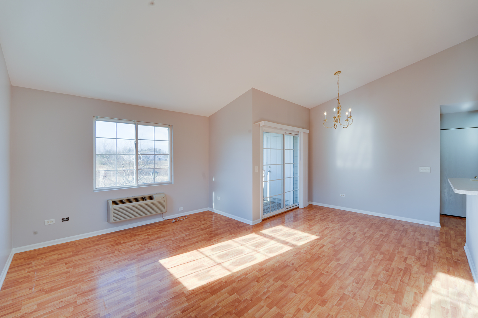 1231 Silverstone Drive, Unit 1231 Carpentersville, IL 60110 - Photo 3 of 22 a view of empty room with wooden floor and fan