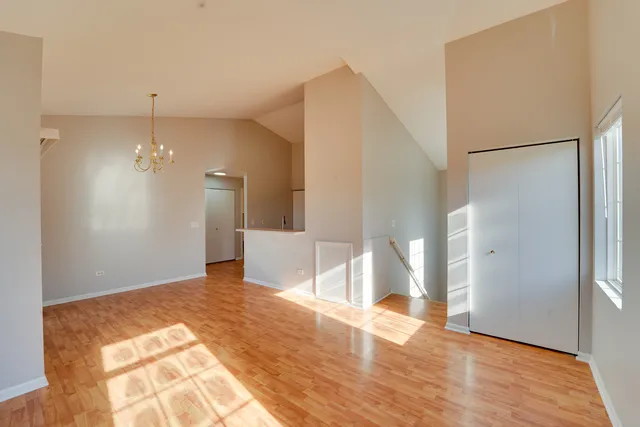 a view of a kitchen with wooden floor and a refrigerator