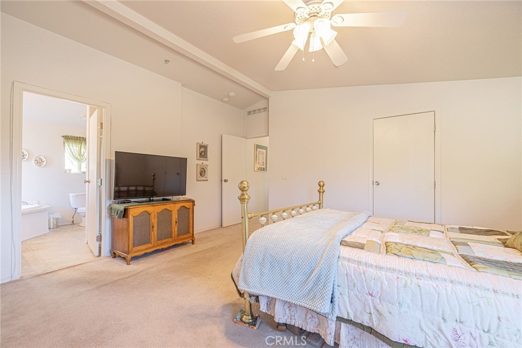 29520 Piani Road Pearblossom, CA 93553 - Photo 20 of 40 a bedroom with a bed and a flat screen tv