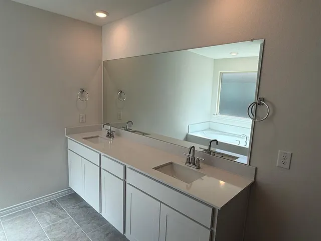 a bathroom with a shower and a sink