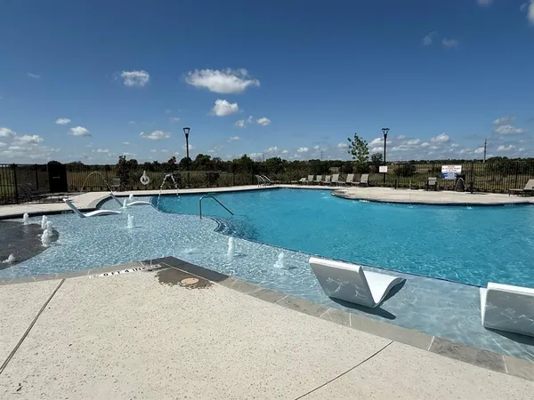 a view of a swimming pool and lounge chair
