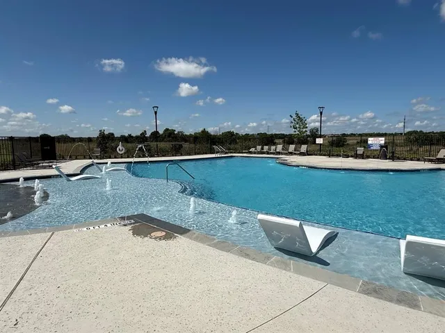 a view of a swimming pool and lounge chair