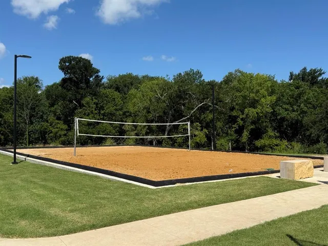 a view of yard with swimming pool and trees in the background