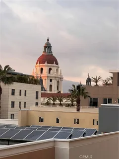 a view of a building with cars park
