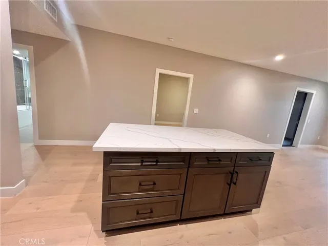a kitchen with stainless steel appliances a refrigerator and a stove top oven