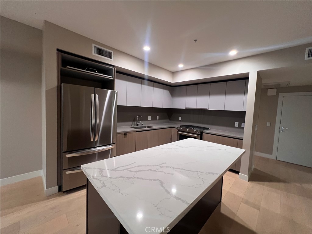 39 South Los Robles Avenue Pasadena, CA 91101 - Photo 13 of 36 a kitchen with stainless steel appliances a refrigerator and a stove top oven