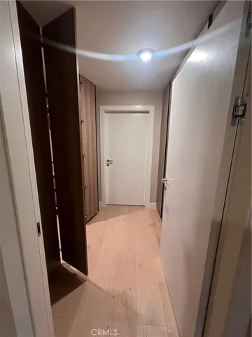 a view of an empty room with a floor to ceiling window and an empty room