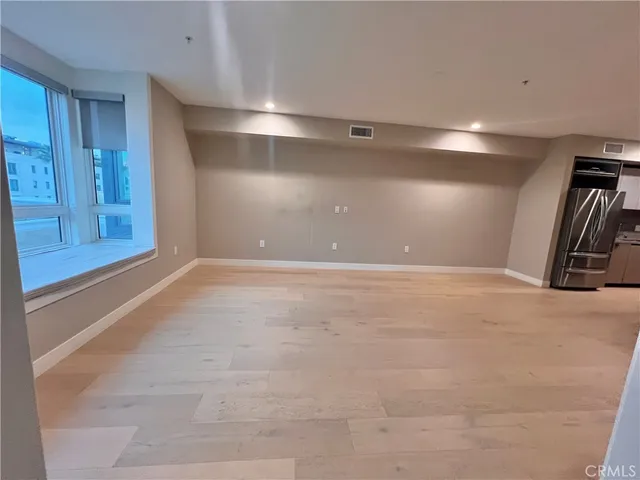 an empty room with a empty space and windows