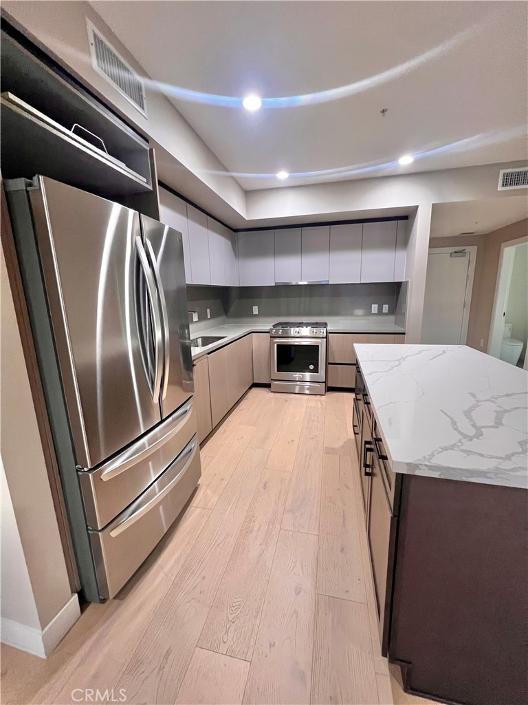 39 South Los Robles Avenue Pasadena, CA 91101 - Photo 5 of 36 a kitchen with stainless steel appliances granite countertop a refrigerator and a sink