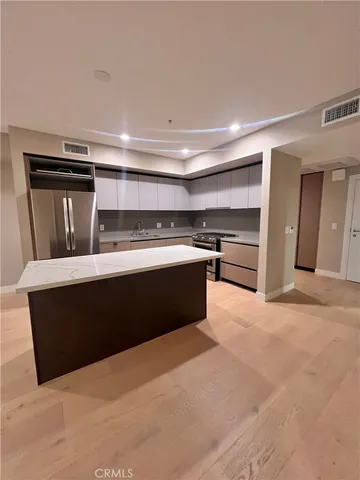 a kitchen with stainless steel appliances a stove and more cabinets