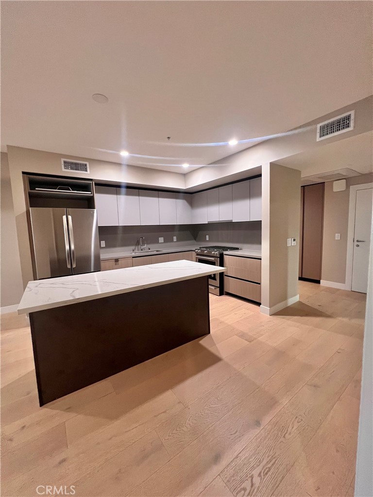 39 South Los Robles Avenue Pasadena, CA 91101 - Photo 8 of 36 a kitchen with stainless steel appliances a stove and more cabinets