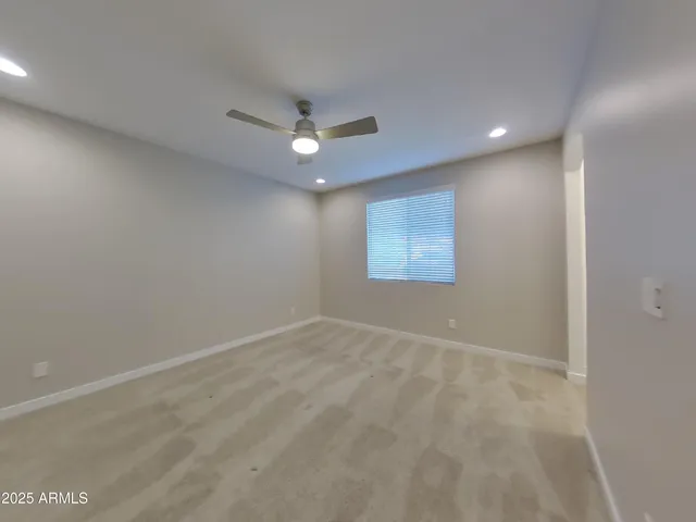 a view of an empty room with a kitchen