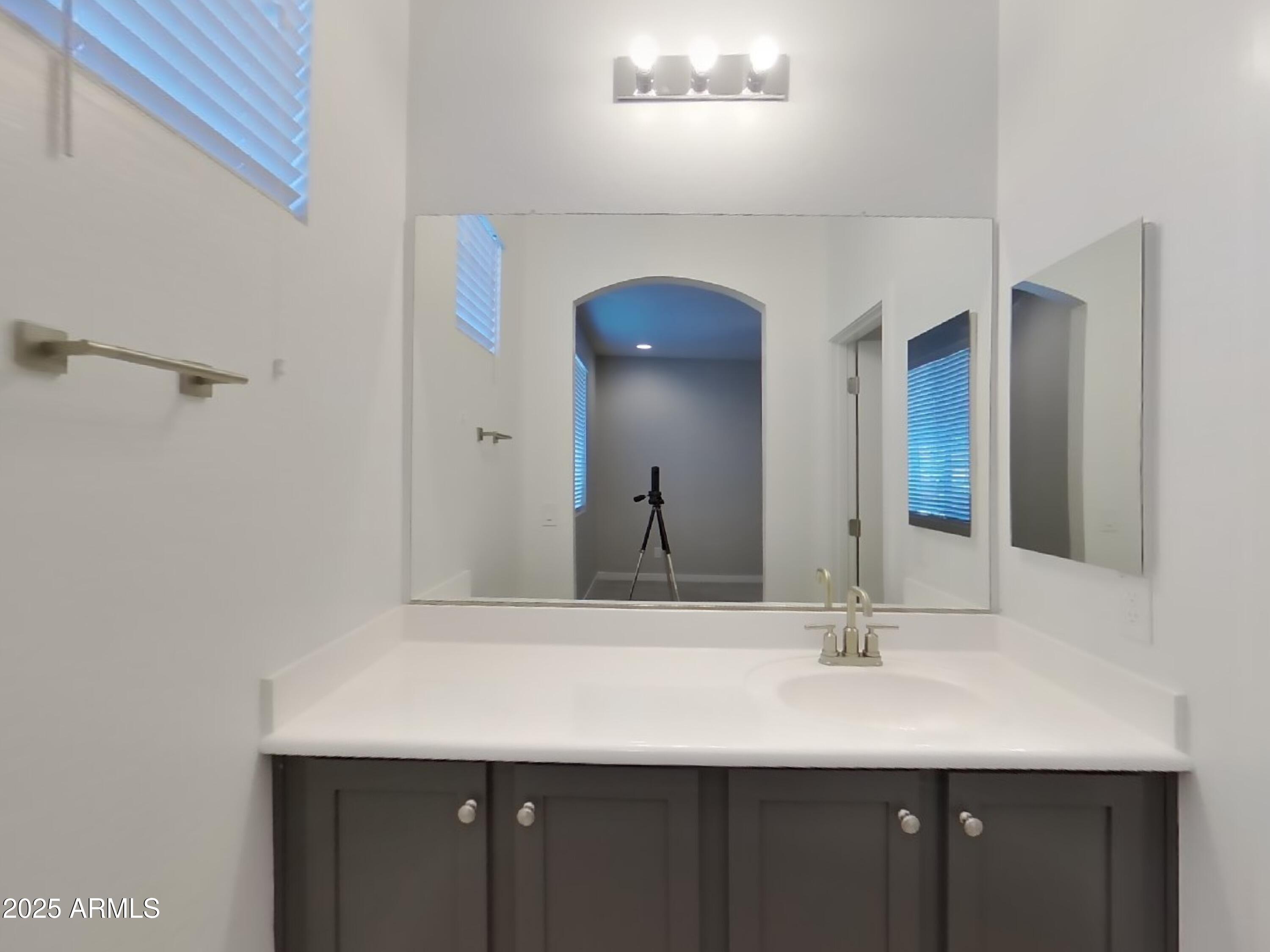 9314 East Strobe Avenue Mesa, AZ 85212 - Photo 12 of 27 a bathroom with a sink and a mirror