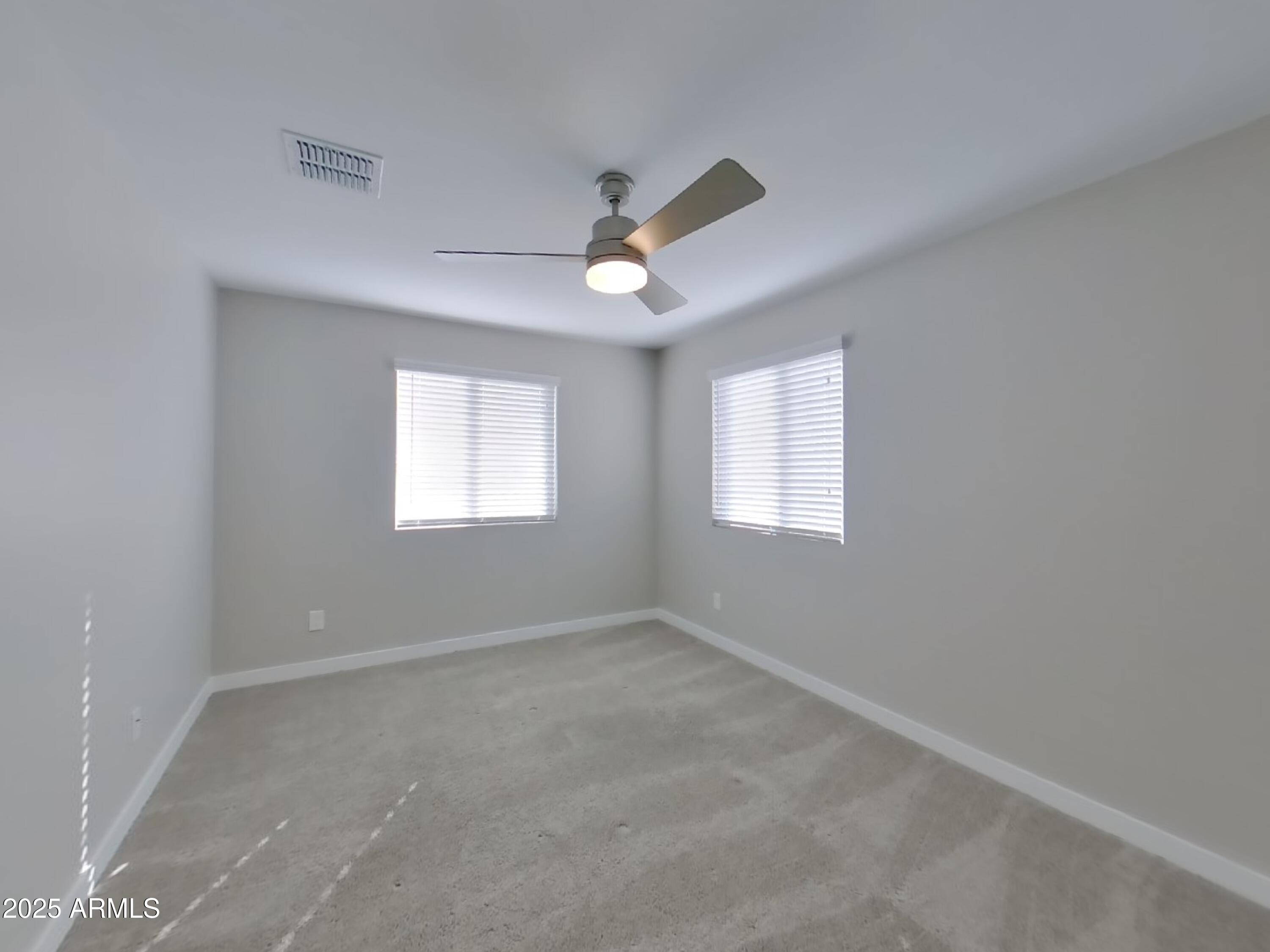 9314 East Strobe Avenue Mesa, AZ 85212 - Photo 13 of 27 an empty room with a window and a fan