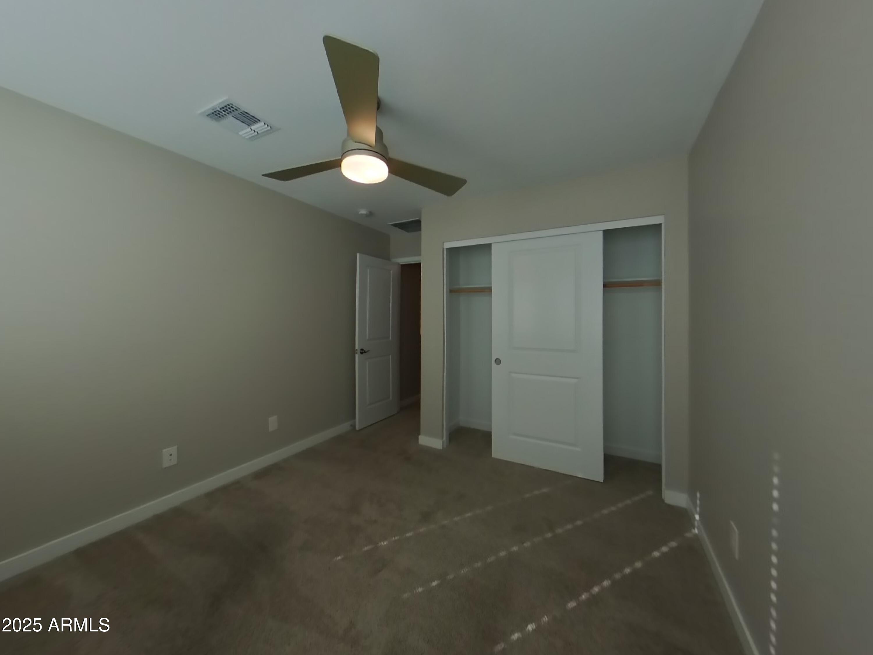 9314 East Strobe Avenue Mesa, AZ 85212 - Photo 16 of 27 an empty room with a ceiling fan and bathroom