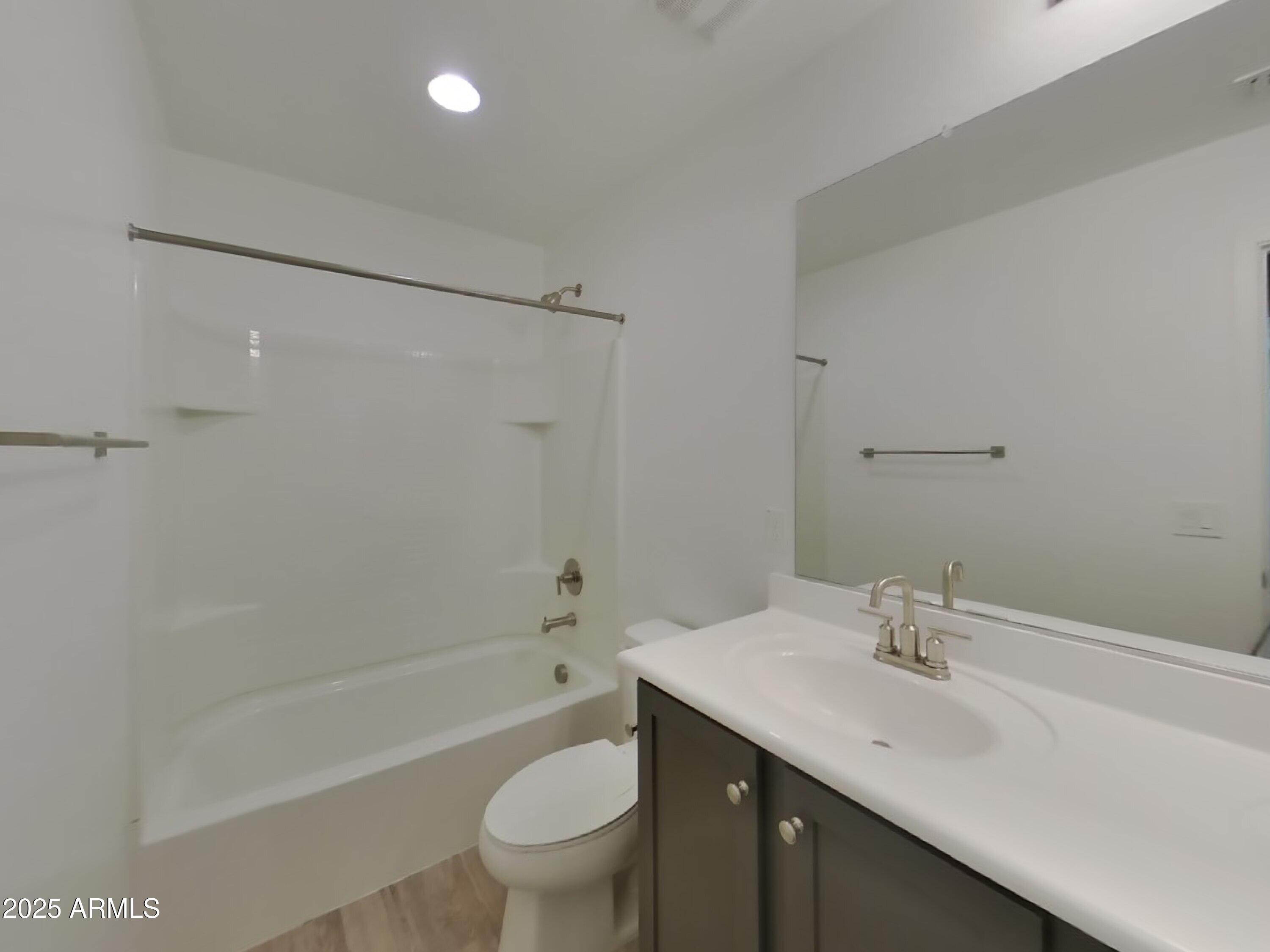9314 East Strobe Avenue Mesa, AZ 85212 - Photo 17 of 27 a bathroom with a sink toilet and shower