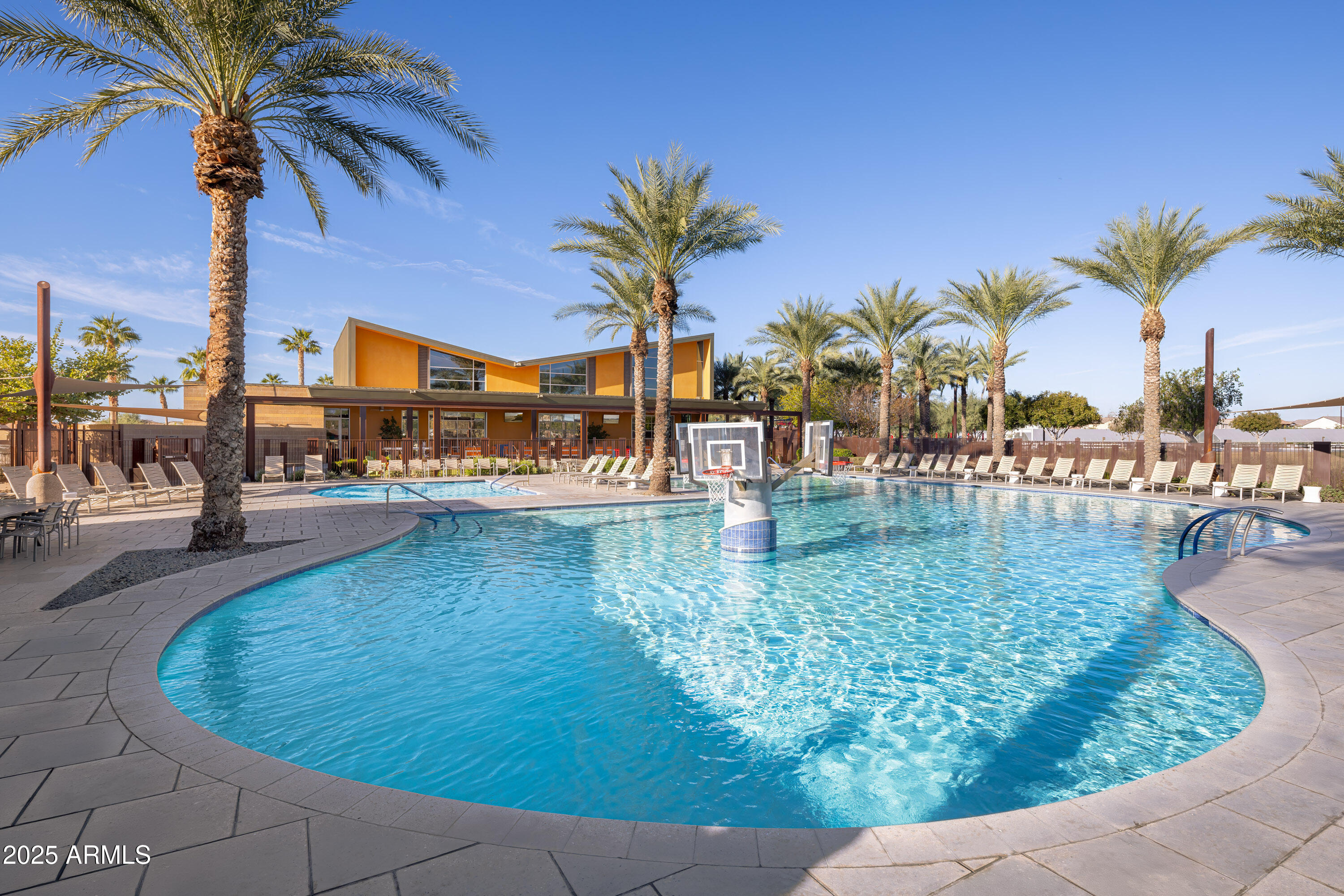 9314 East Strobe Avenue Mesa, AZ 85212 - Photo 23 of 27 a view of a swimming pool with a table and chairs