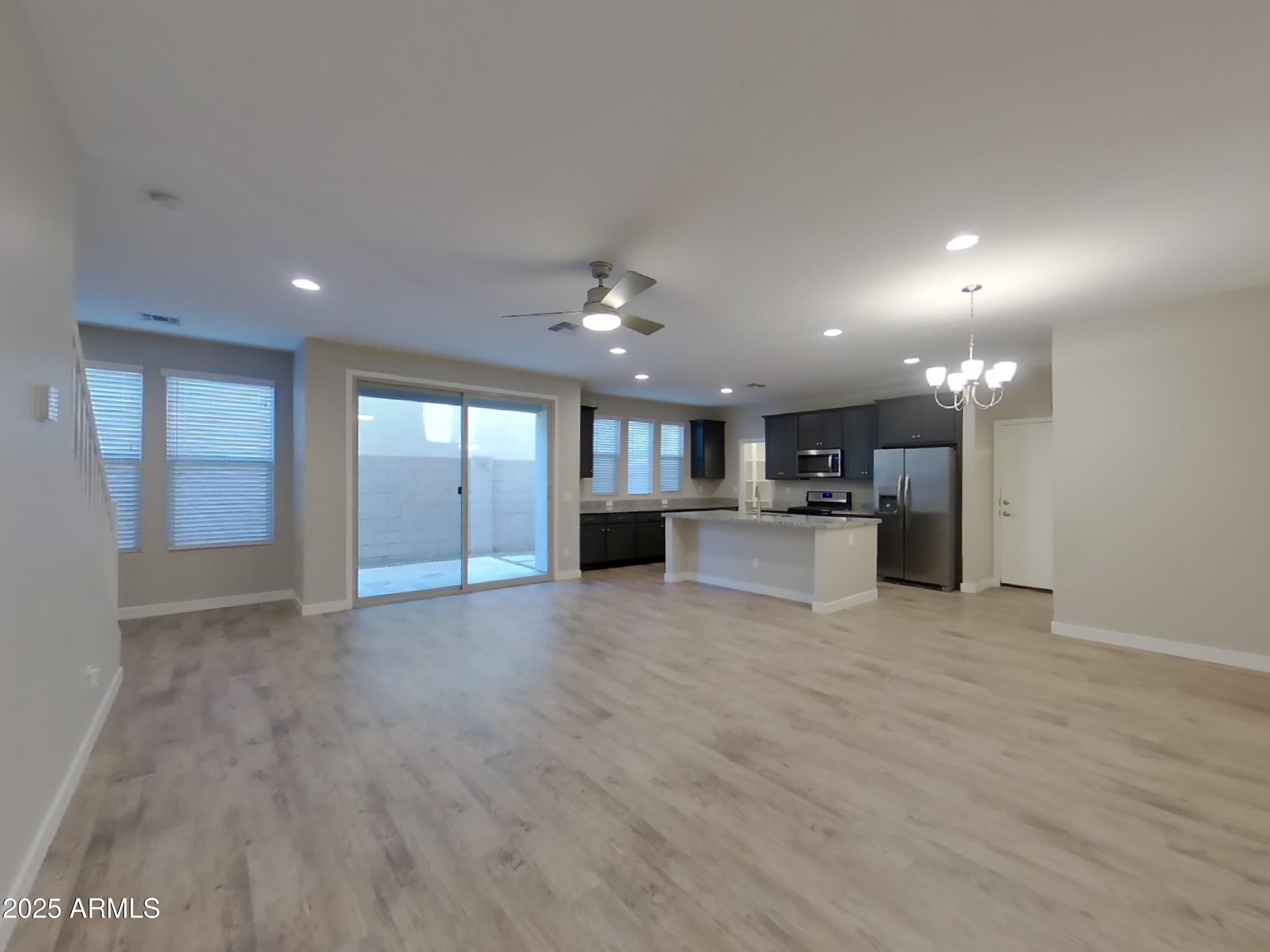 9314 East Strobe Avenue Mesa, AZ 85212 - Photo 2 of 27 a view of an empty room with kitchen and window