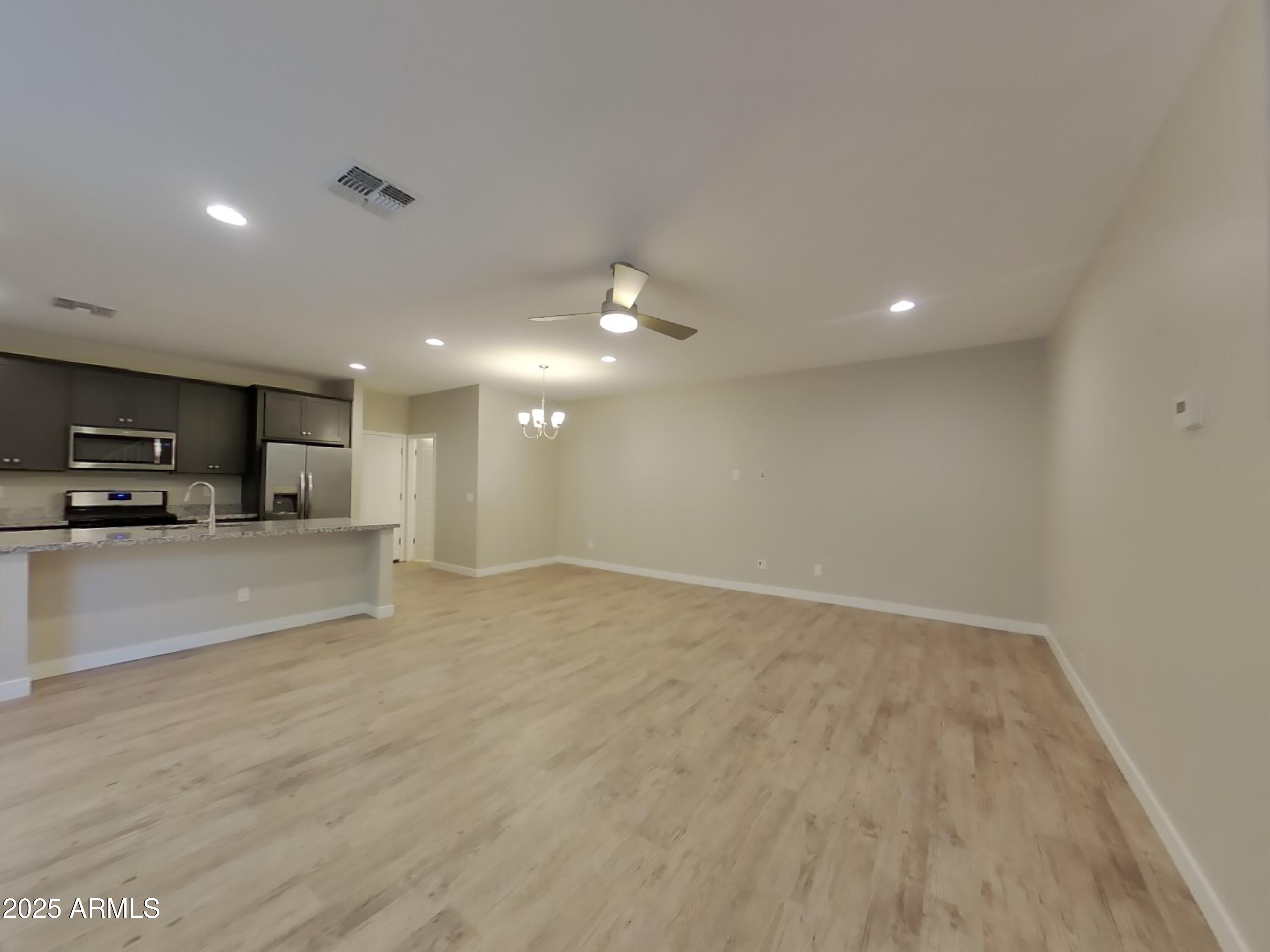 9314 East Strobe Avenue Mesa, AZ 85212 - Photo 5 of 27 a view of an empty room and kitchen view