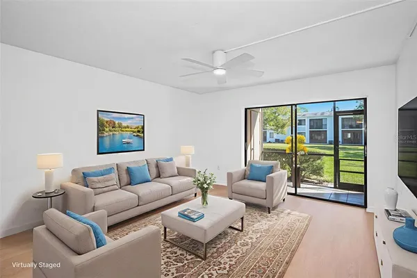 a living room with furniture and floor to ceiling windows