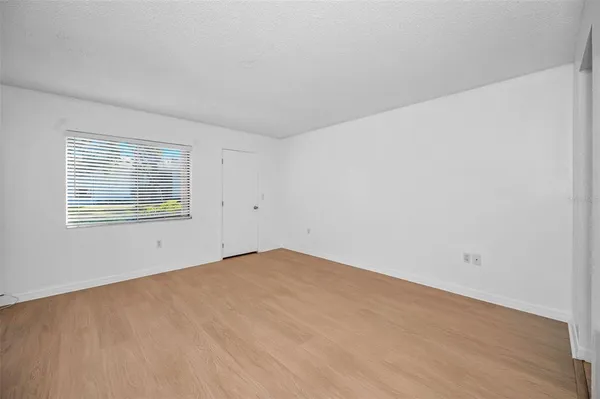 a bedroom with bed and wall painting