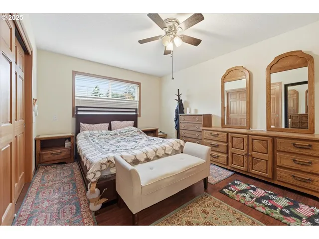 a bedroom with a bed a dresser and dresser
