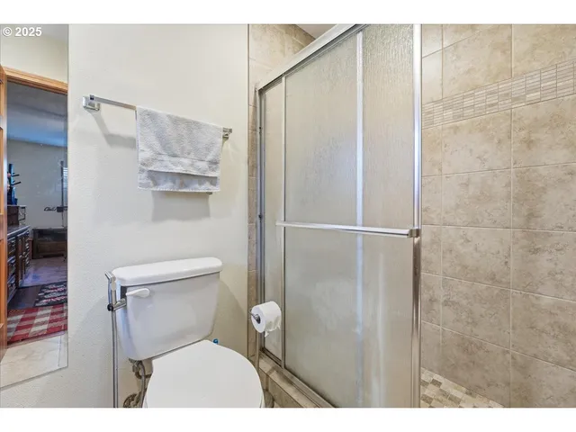 a bathroom with a toilet and a shower