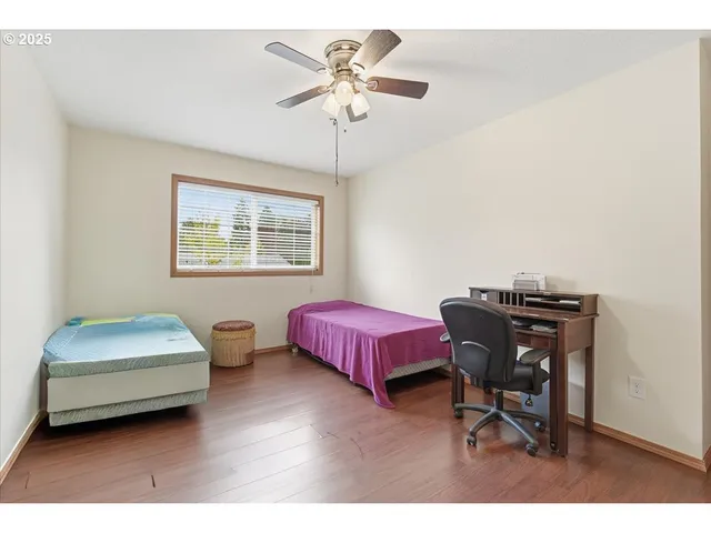 a bedroom with bed and a chandelier
