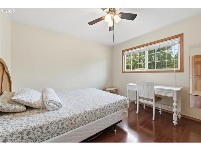 a bedroom with a bed and a chair in it