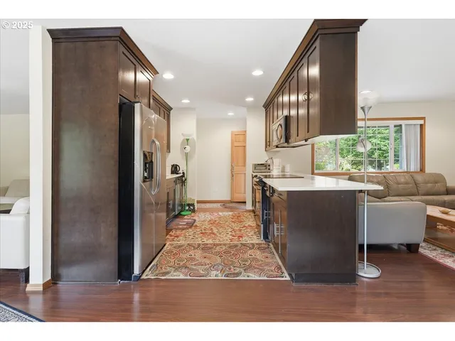 a living room with furniture and a dining table