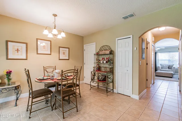 a view of a dining room with furniture and chandelier