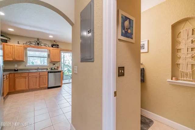 a large kitchen with a large counter top stainless steel appliances and cabinets