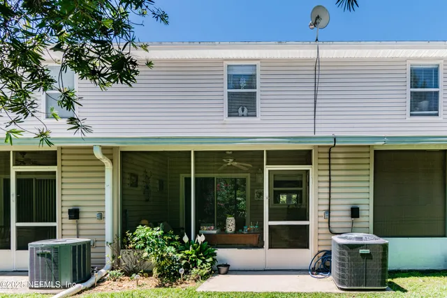 a view of a brick house with potted plants