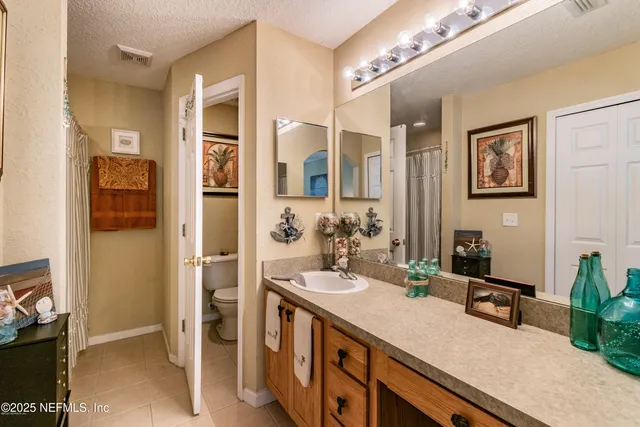 a bathroom with a double vanity sink a mirror and a shower