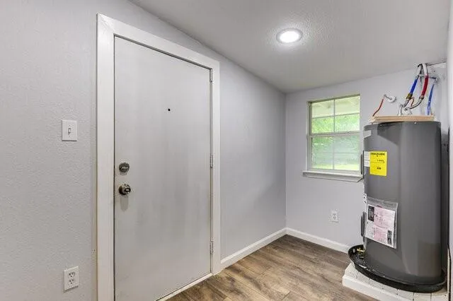 a view of room with window and wooden floor
