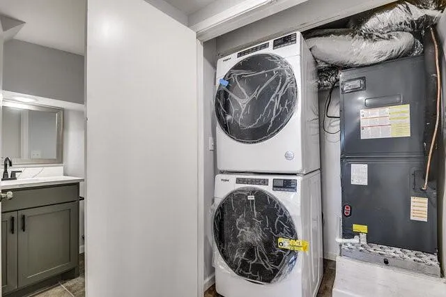 a utility room with sink dryer and washer