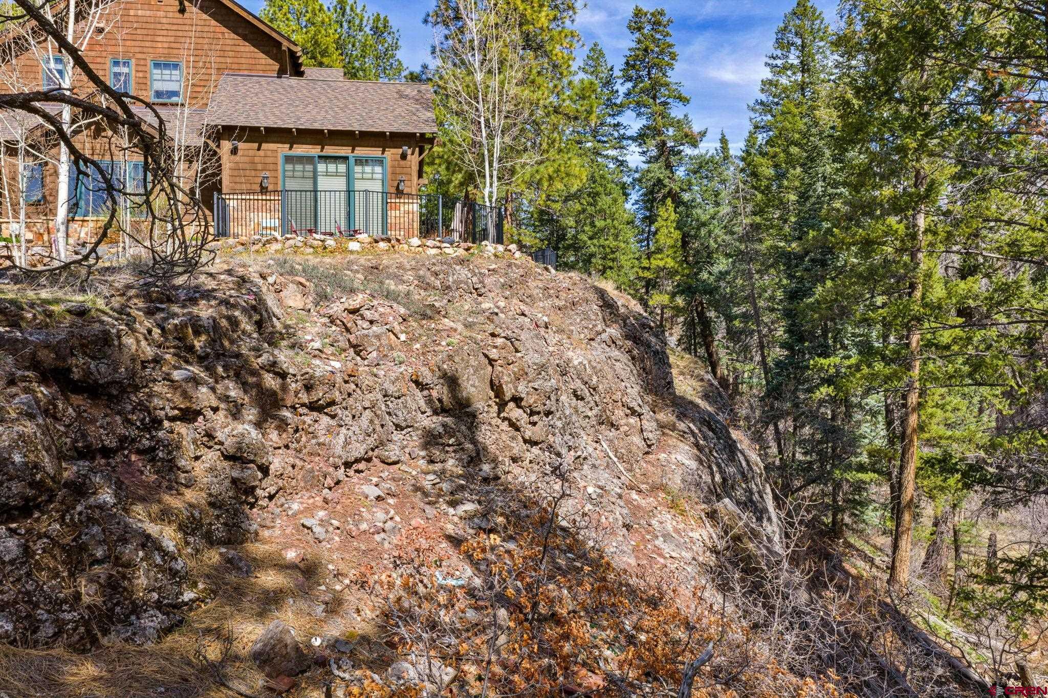 211 Cliffs Edge Drive Durango, CO 81301 - Photo 14 of 24 a front view of a house with a yard