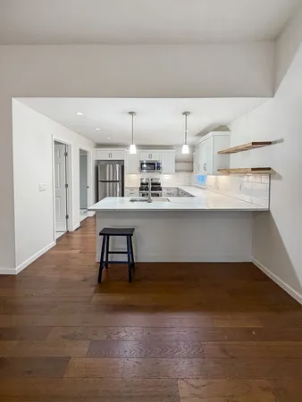 a room with counter space and painting on the wall