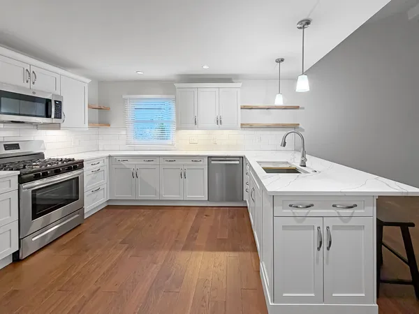 a kitchen with sink cabinets and stainless steel appliances