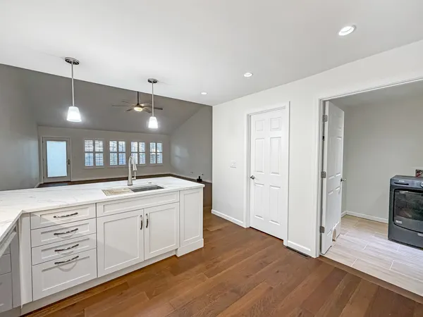 a large bathroom with a large mirror vanity and shower