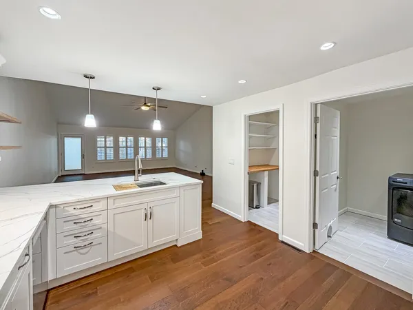 a large bathroom with a large mirror vanity and shower