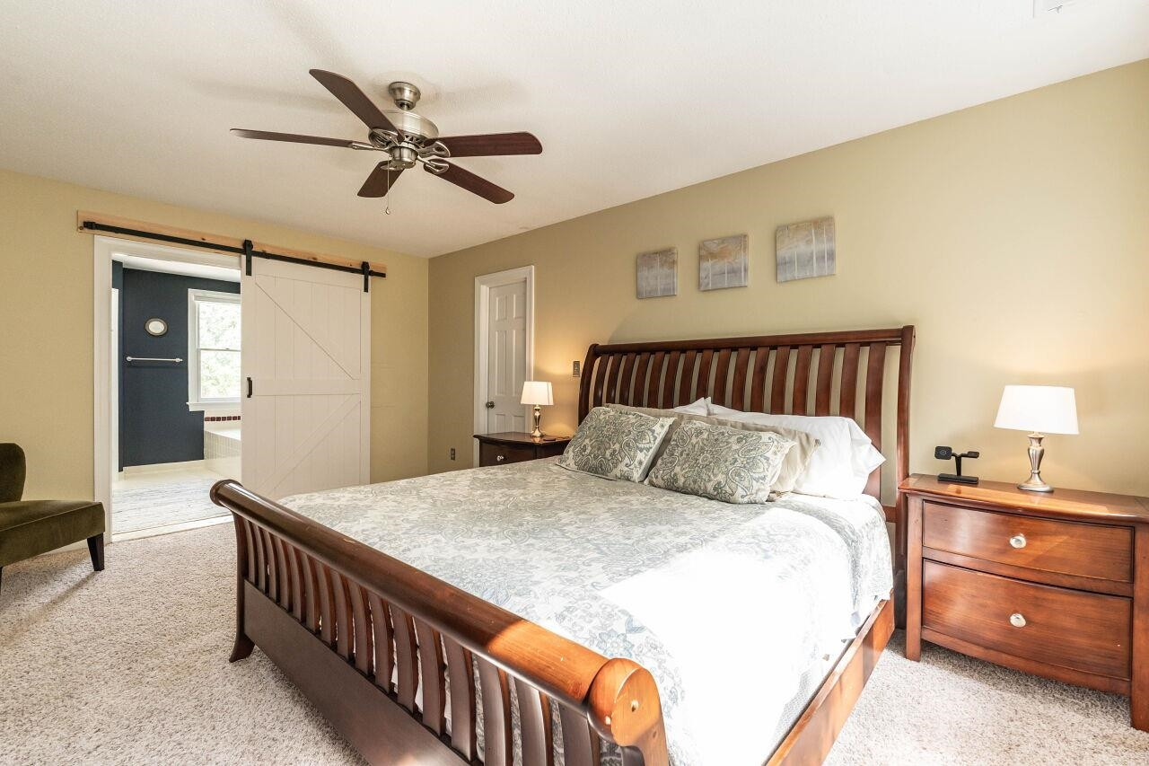 5924 Clearsprings Drive Wake Forest, NC 27587 - Photo 19 of 37 a bedroom with a bed and a chandelier