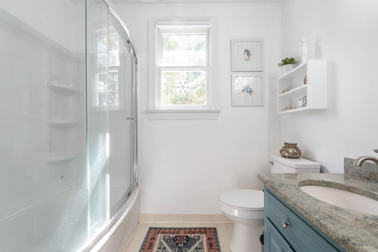 5924 Clearsprings Drive Wake Forest, NC 27587 - Photo 24 of 37 a bathroom with a granite countertop toilet a sink and a mirror