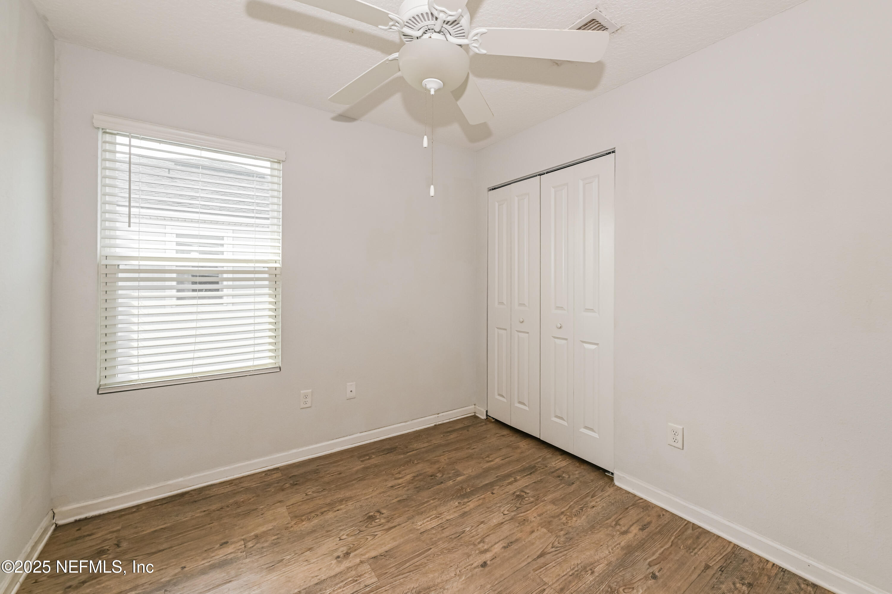 548 Eiseman Way Jacksonville, FL 32216 - Photo 12 of 15 an empty room with a window and a fan