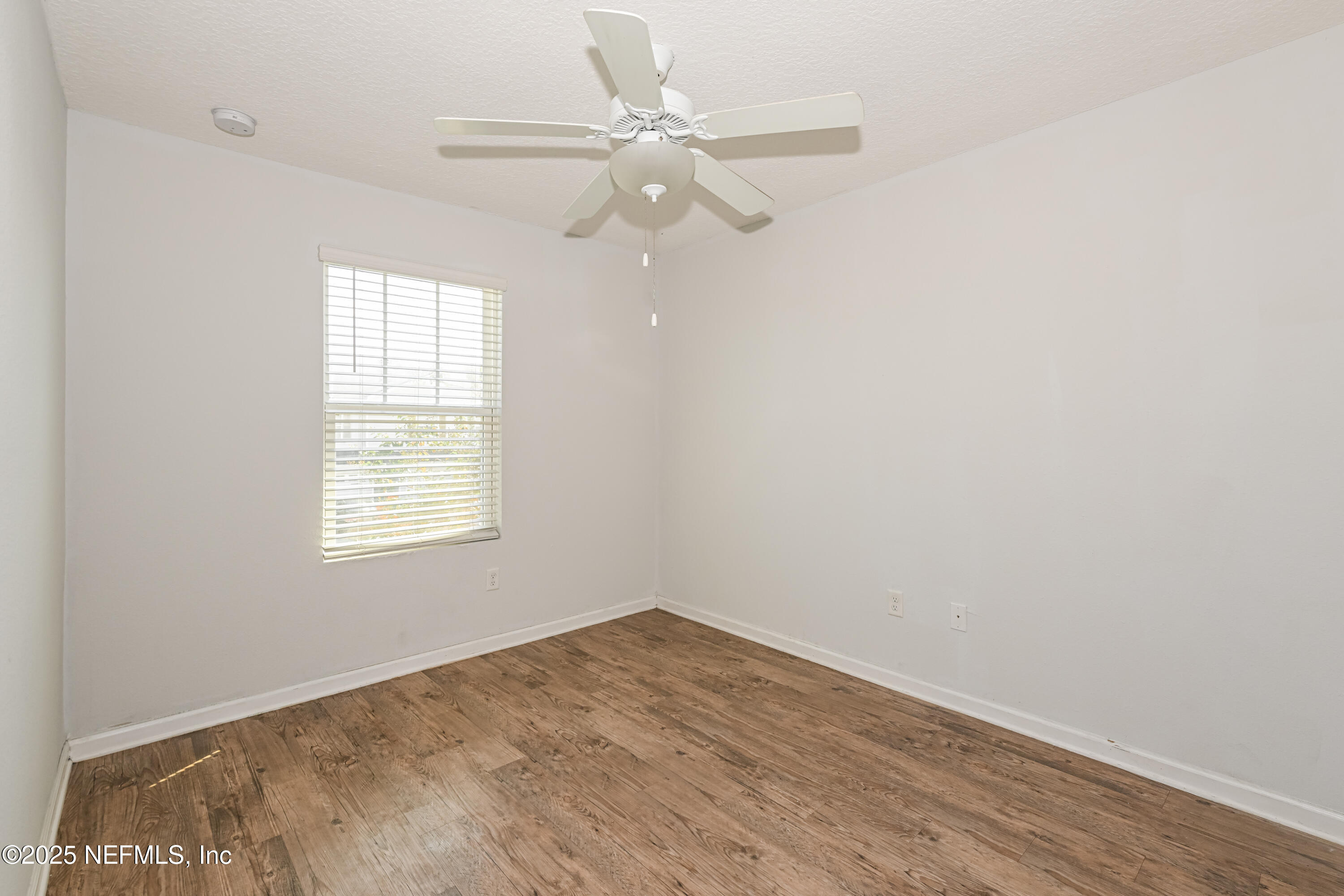 548 Eiseman Way Jacksonville, FL 32216 - Photo 13 of 15 an empty room with a window and a fan