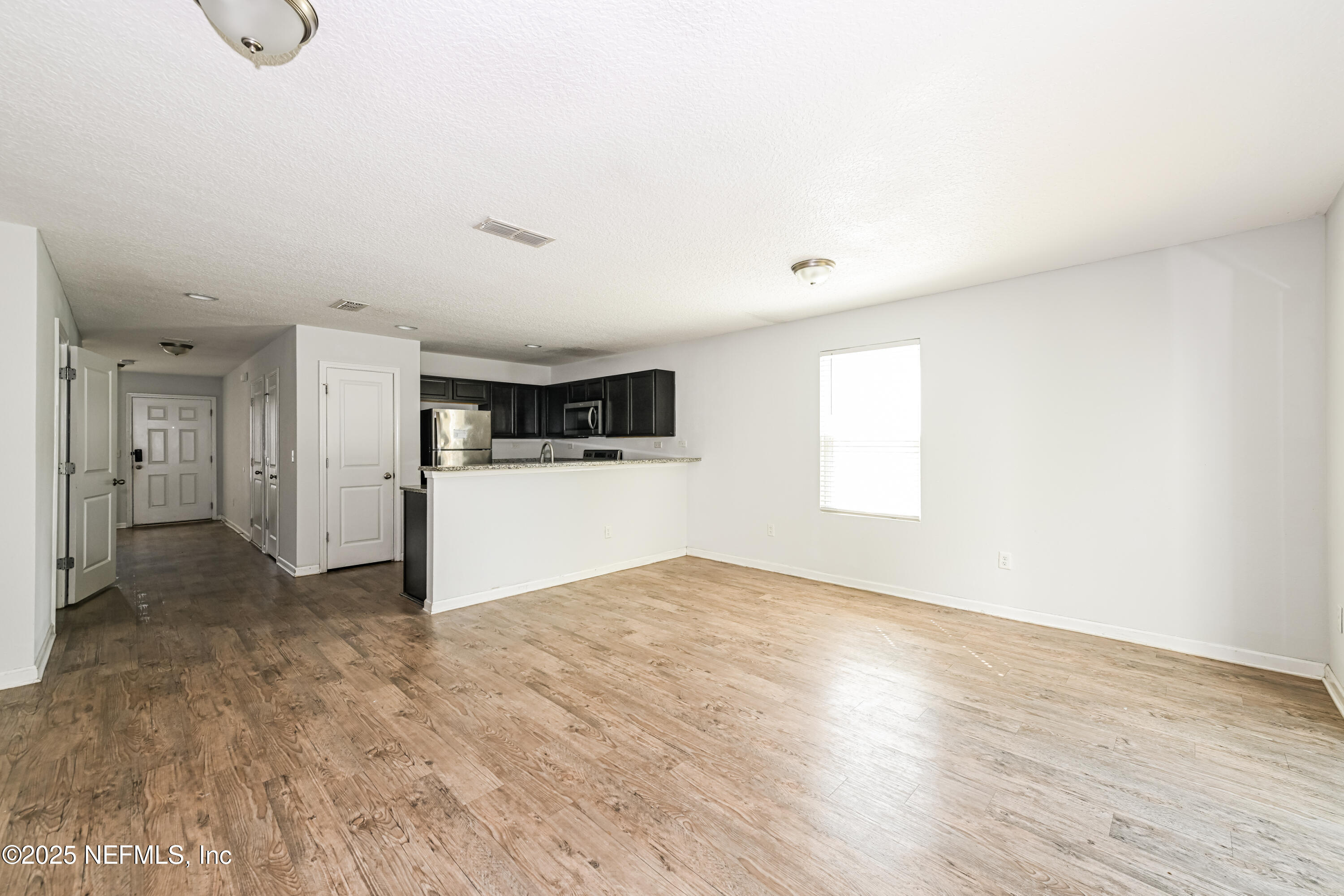 548 Eiseman Way Jacksonville, FL 32216 - Photo 4 of 15 a view of a livingroom with wooden floor