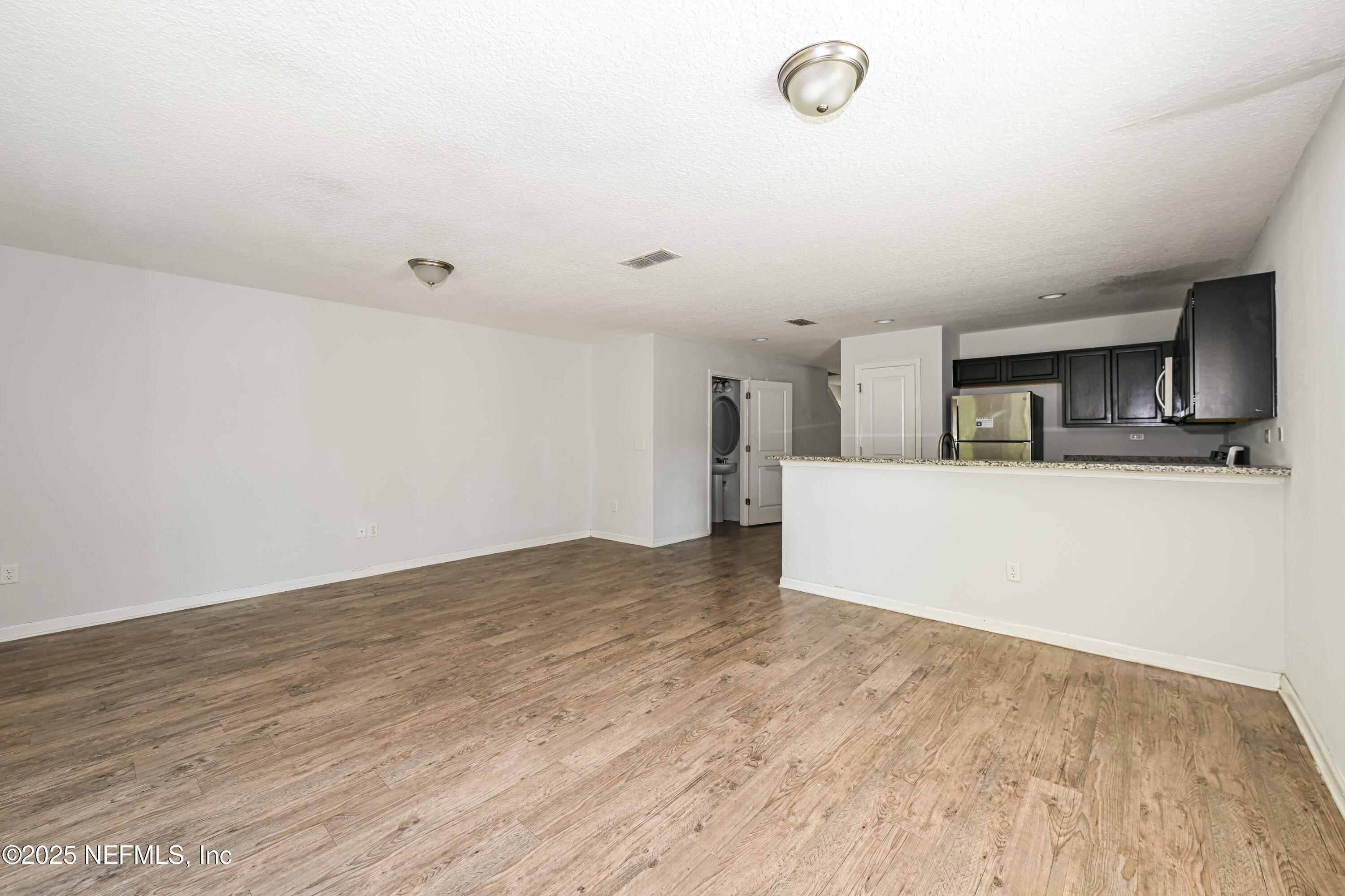 548 Eiseman Way Jacksonville, FL 32216 - Photo 5 of 15 a view of a kitchen with a sink and a refrigerator