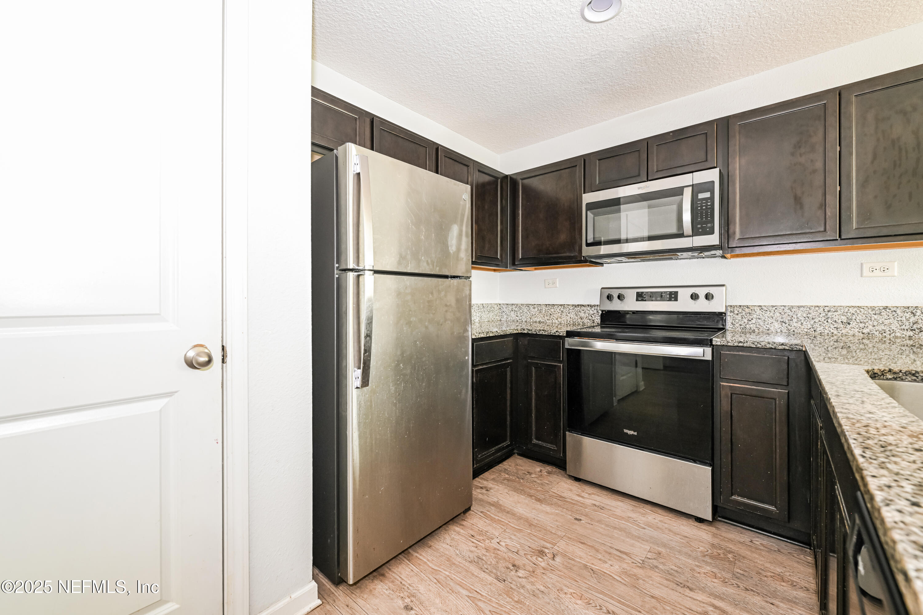 548 Eiseman Way Jacksonville, FL 32216 - Photo 6 of 15 a kitchen with stainless steel appliances and refrigerator